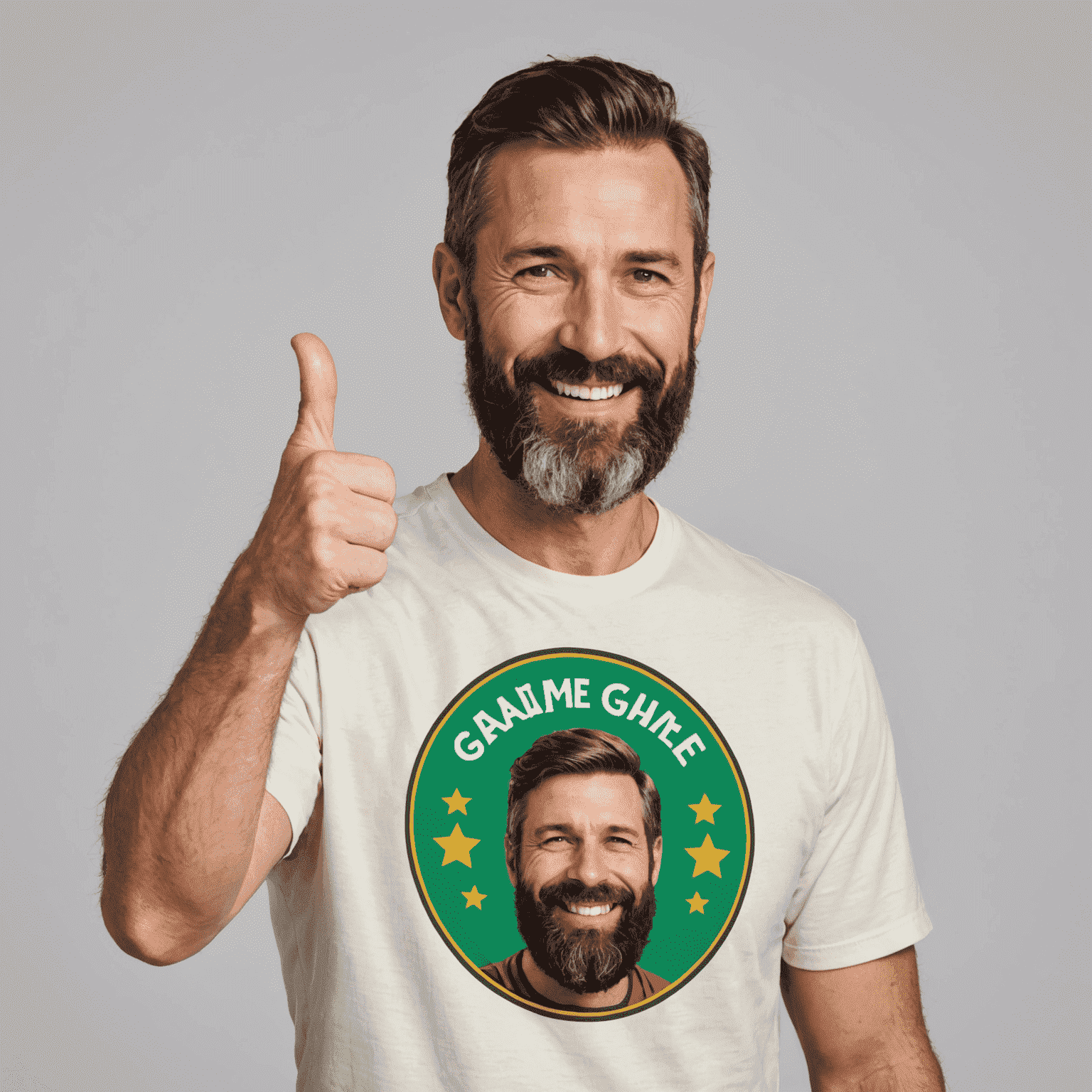 A cheerful man in his 40s with a beard, wearing a quirky game-themed t-shirt and giving a thumbs up